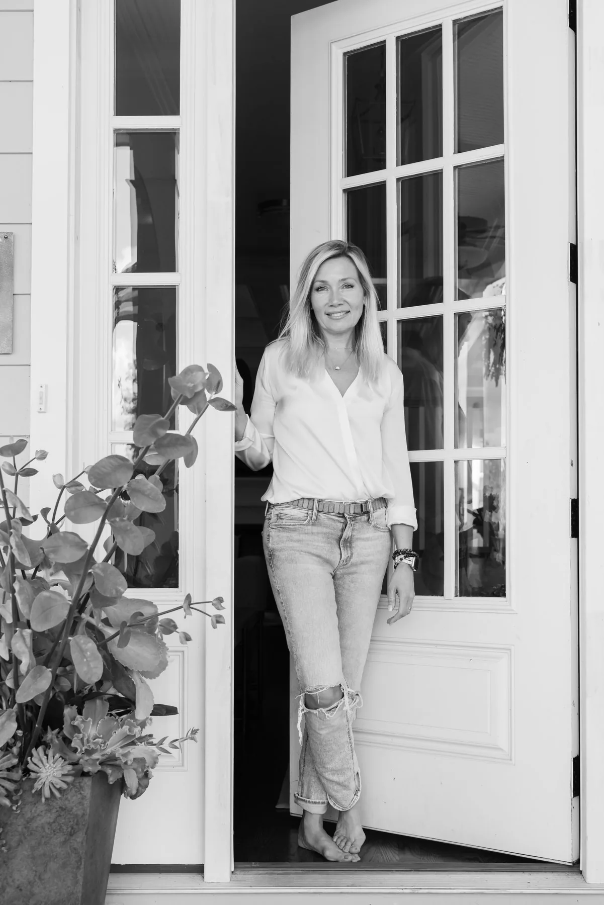 Susan Jenkins, Lead Designer of Shelter + Sanctuary, standing in a doorway