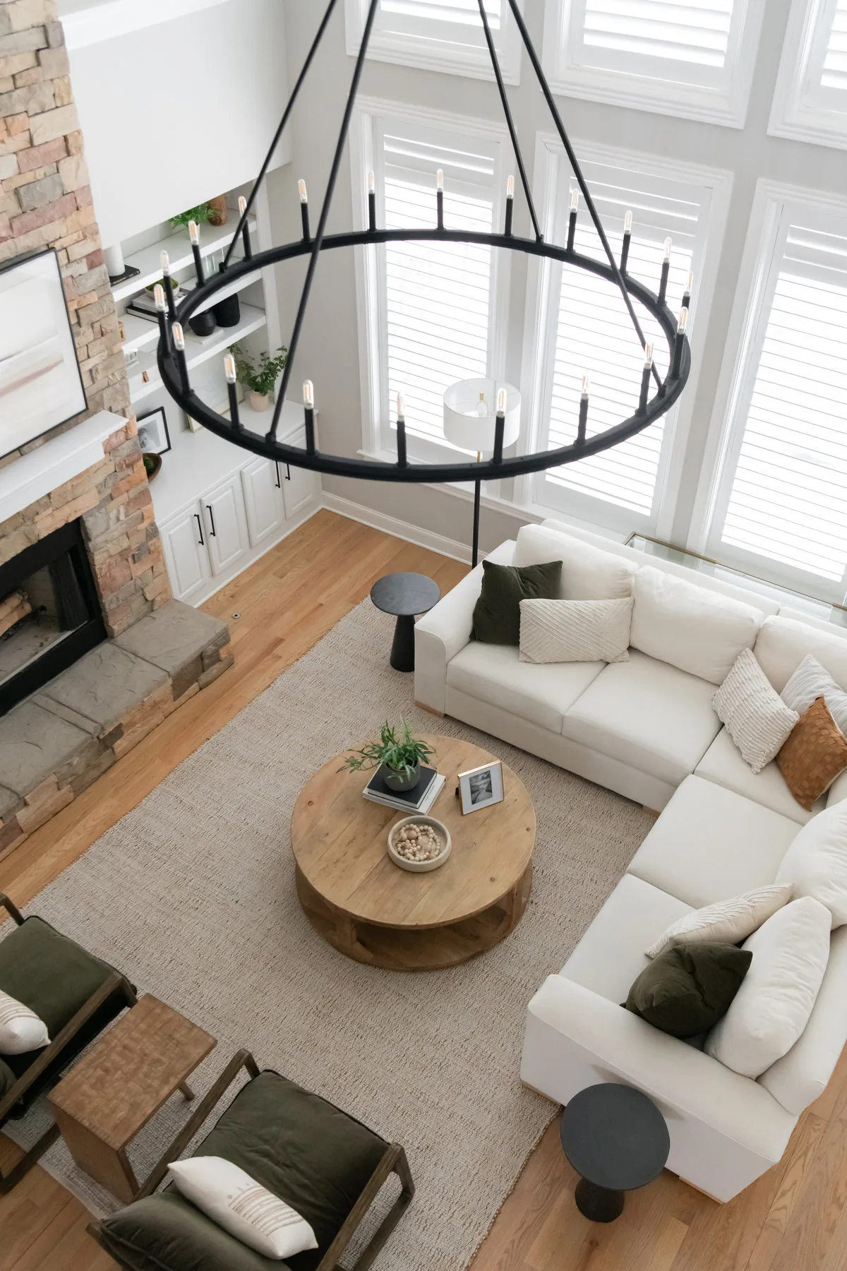 Living room with round iron chandelier and white sectional, Good Bones project