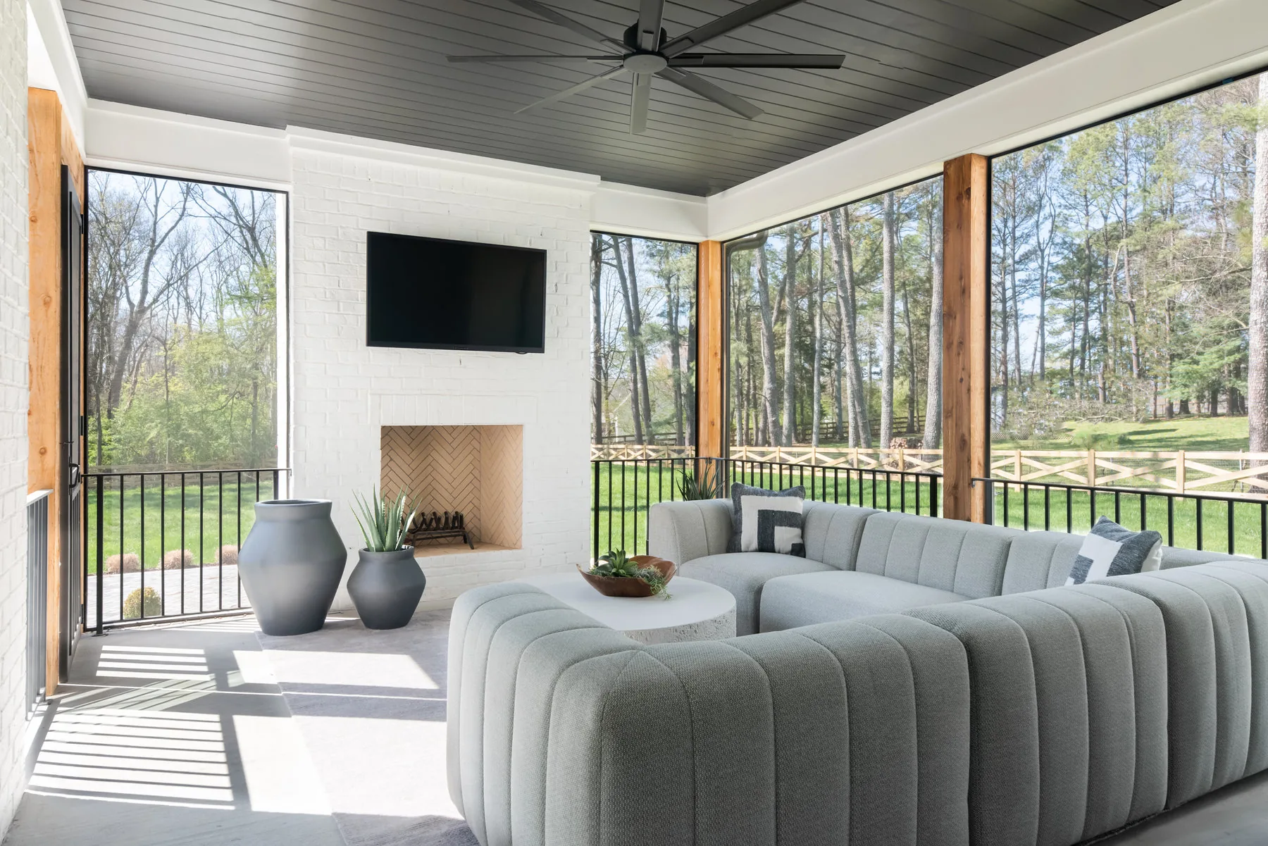 Screened porch lounge with dark ceiling and fireplace, Modern Mood project