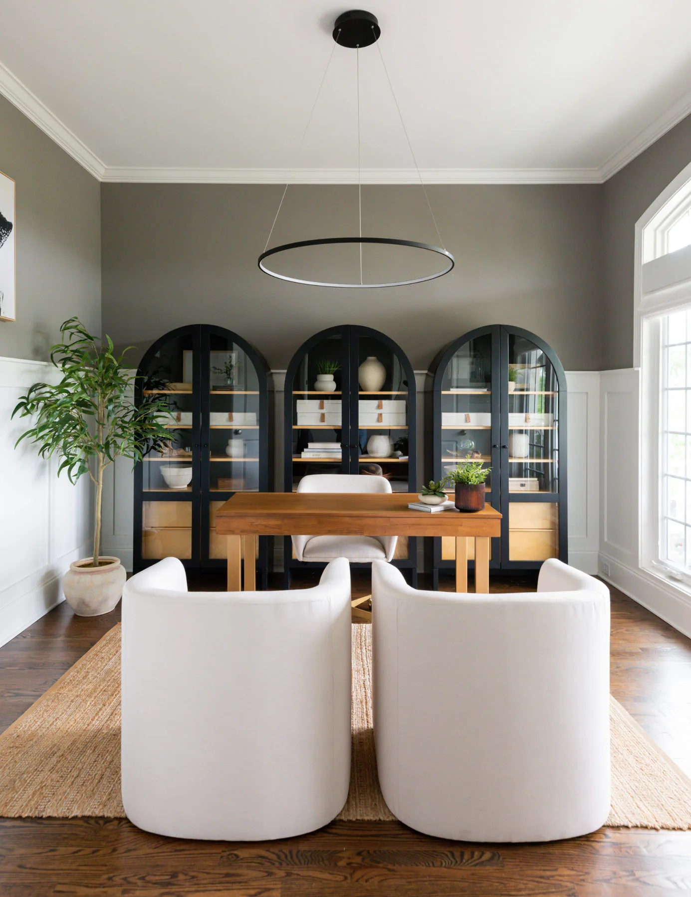 Dining room with arched black display cabinets, River House project